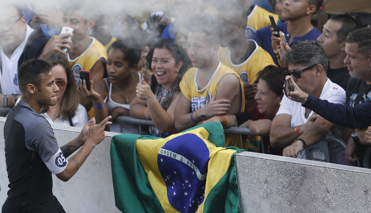 Neymar saat melakukan selebrasi bersama fans pada laga sepak bola mini yang merupakan bagian dari  Neymar Junior Institute project di  Praia Grande, Sao Paulo, Brasil, (9/7/2016). (AFP/Miguel Schincariol)