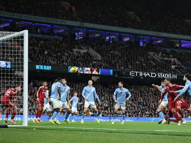 Pemain Liverpool, Virgil van Dijk, mencetak gol melalui tandukan kepalanya ke gawang Manchester City pada lanjutan Liga Inggris Etihad Stadium, Minggu (09/1, 1/2025) malam WIB. (AFP/Darren Staples)