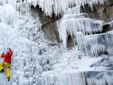 Seorang pria memanjat dinding tebing es buatan di Liberec, Republik Ceko, Kamis (1/3). Meski buatan, tidak sembarang orang bisa menaklukkan tebing es tersebut. (AP Photo/Petr David Josek)