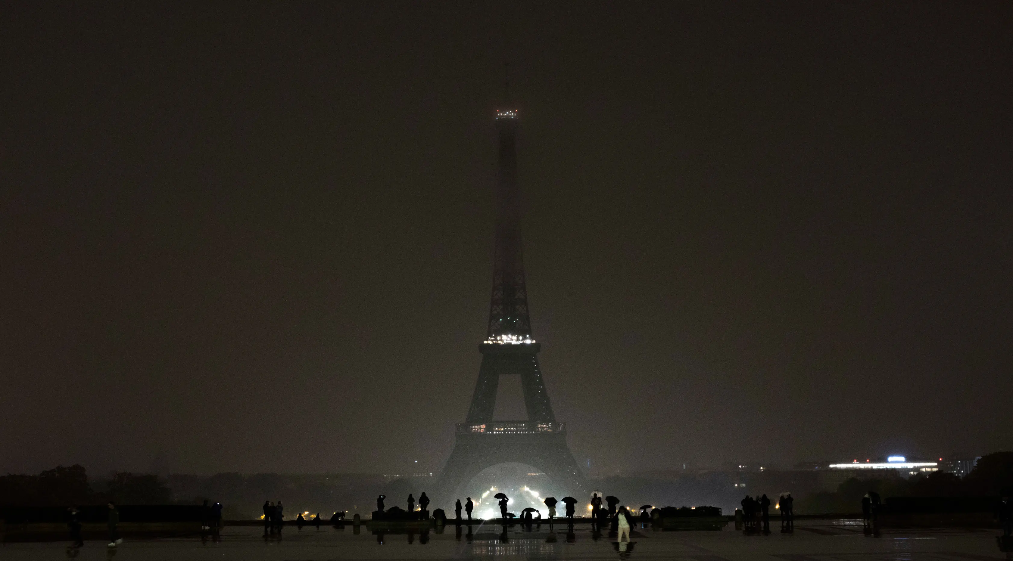 Pemandangan lampu Menara Eiffel yang dipadamkan di Paris, Senin (2/10). Turut berdukacita terhadap penembakan massal di Las Vegas, Amerika Serikat, lampu Menara Eiffel dimatikan sebagai penghormatan kepada para korban. (AP/Kamil Zihnioglu)