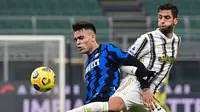 Striker Inter Milan, Lautaro Martinez (kiri) berebut bola dengan gelandang Juventus, Rodrigo Bentancur dalam laga lanjutan Liga Italia Serie A 2020/21 pekan ke-18 di San Siro Stadium, Minggu (17/1/2021). Inter Milan menang 2-0 atas Juventus. (AFP/Miguel Medina)