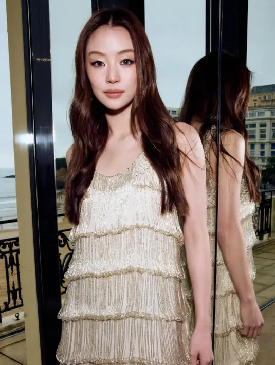 Miu Natsha Taechamongkalapiwat tampil mengenakan gaun ecru berbahan georgette crepe, Look 59 dari koleksi Métiers d’Art 2026 dari Chanel.
Penampilannya dilengkapi dengan aksesori, tas, dan sepatu dari Chanel, serta riasan dari Chanel Makeup. (Foto: Chanel.dok)