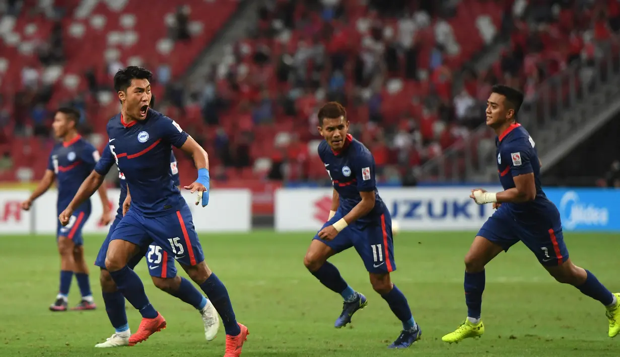 Gelandang Timnas Singapura, Song Uiyoung (kiri) berselebrasi usai mencetak gol ke gawang Indonesia pada pertandingan leg kedua semifinal Piala AFF 2020 di National Stadium, Sabtu (25/12/2021). Laga dimenangkan Indonesia 4-2 lewat perpanjangan waktu 2 x 15 menit. (AFP/Roslan Rahman)