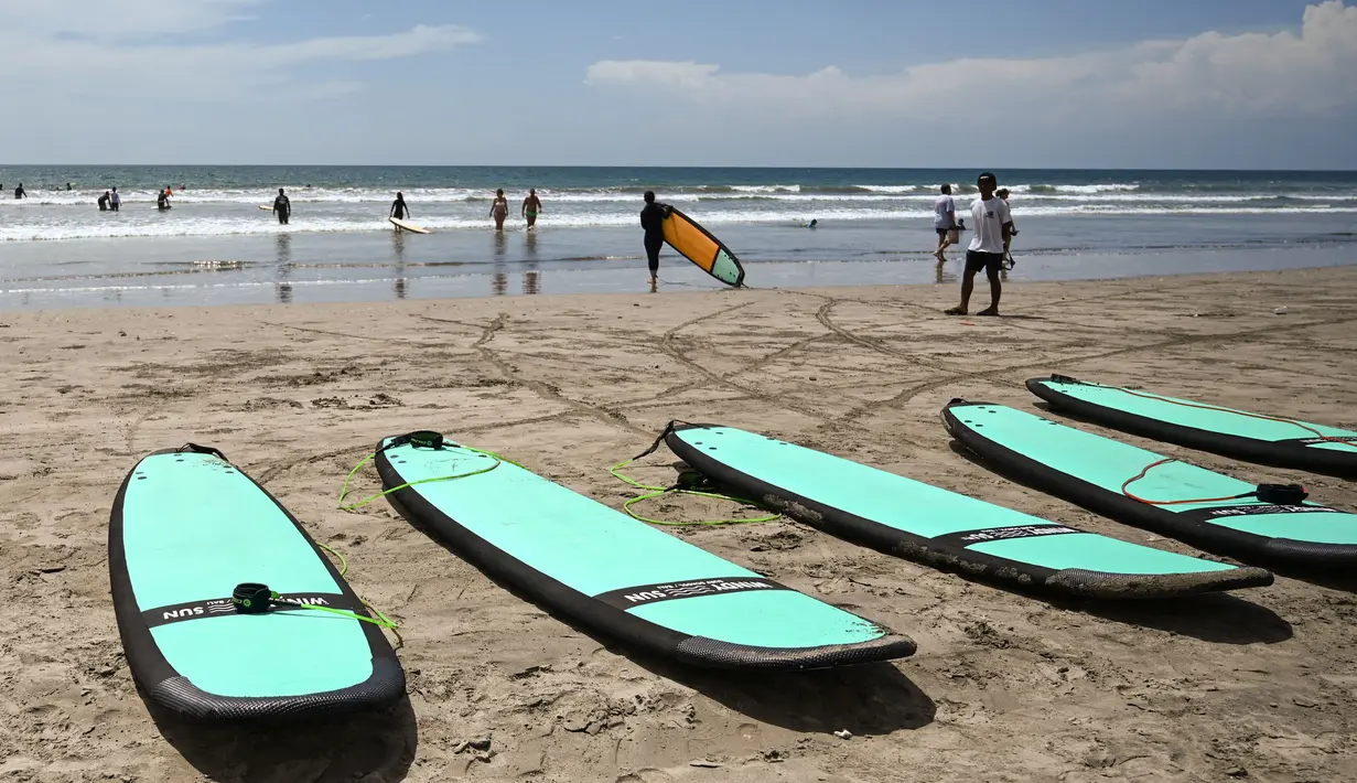 Sejumlah wisatawan saat berada di pantai Kuta, Bali, pada 8 Desember 2023. (SONNY TUMBELAKA/AFP)