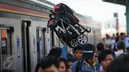 Seorang penumpang membawa kereta bayi setelah turun dari Comuter Line di Stasiun Manggarai, Jakarta, Selasa (28/3). (Liputan6.com/Faizal Fanani)