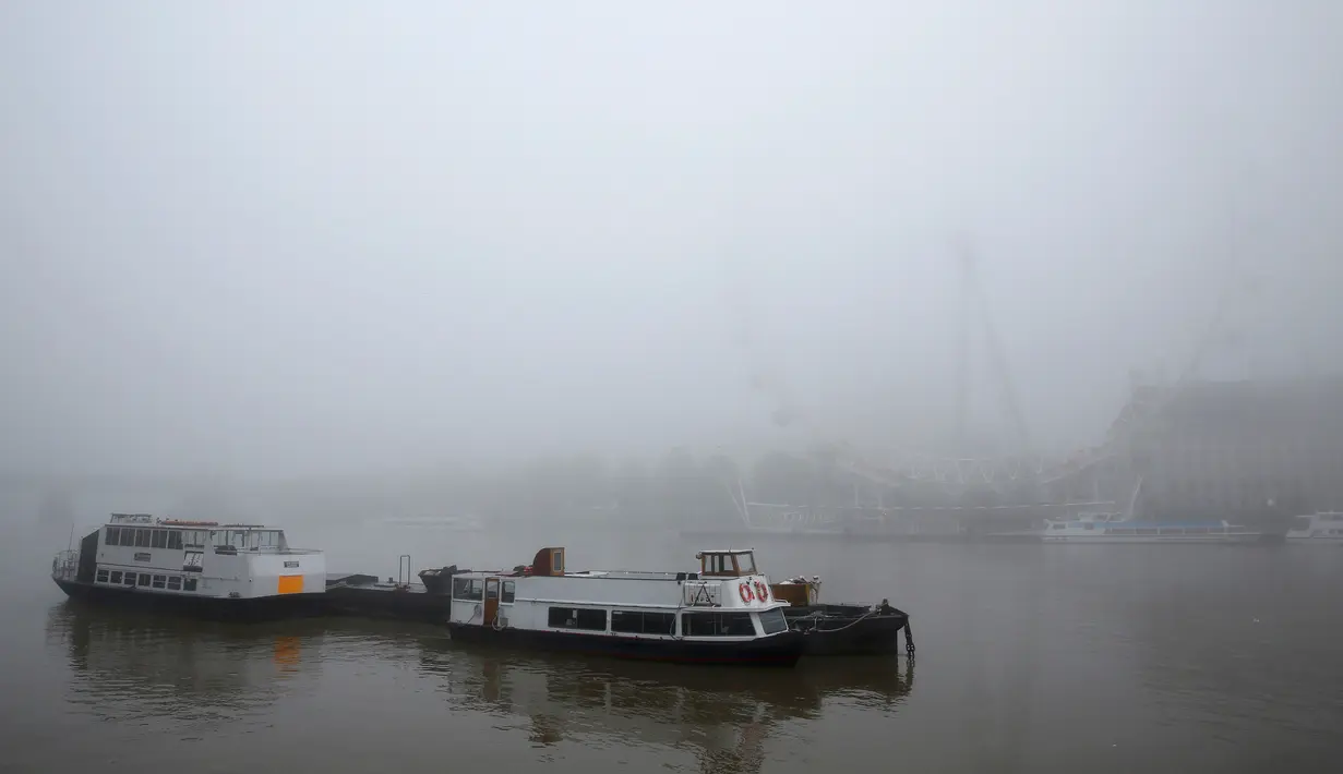 Aktifitas di perairan depan London Eye mengalami perlambatan akibat kabut tebal yang melanda London, Inggris, Senin (2/11/2015). Gangguan Penerbangan juga dialami negara Eropa lainnya. (REUTERS/Stefan Wermuth)