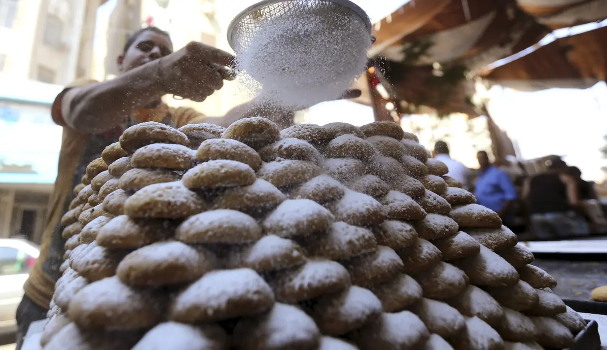 Seorang pekerja membuat permen "Kahk" untuk perayaan Idul Fitri, Kairo, (27/7/14). (REUTERS/Mohamed Abd El Ghany)