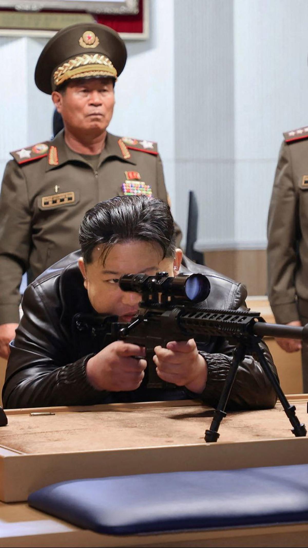 Dengan memicingkan mata kirinya, Kim mencermati target sembari menarik pelatuk. Gayanya tampak mirip seorang sniper yang menembak musuhnya.&nbsp;KCNA VIA KNS/AFP