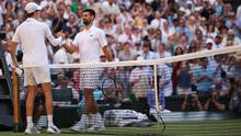 Petenis Italia, Jannik Sinner (kiri), berjabat tangan dengan petenis Serbia, Novak Djokovic, setelah memenangkan pertandingan semifinal tunggal putra mereka pada hari&nbsp;ke-12 Kejuaraan Wimbledon 2025 di All England Lawn Tennis and Croquet Club di Wimbledon, London barat daya, pada 11 Juli 2025. (HENRY NICHOLLS/AFP)