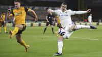 Bek Leeds United, Pascal Struijk (kanan) melepaskan tendangan dibayangi seorang pemain Wolverhampton Wanderers, dalam laga Lanjutan Liga Inggris 2020/21 pekan ke-25 di Molineux Stadium, Jumat (19/2/2021). Leeds kalah 0-1 dari Wolverhampton. (AP/Nick Potts/Pool)