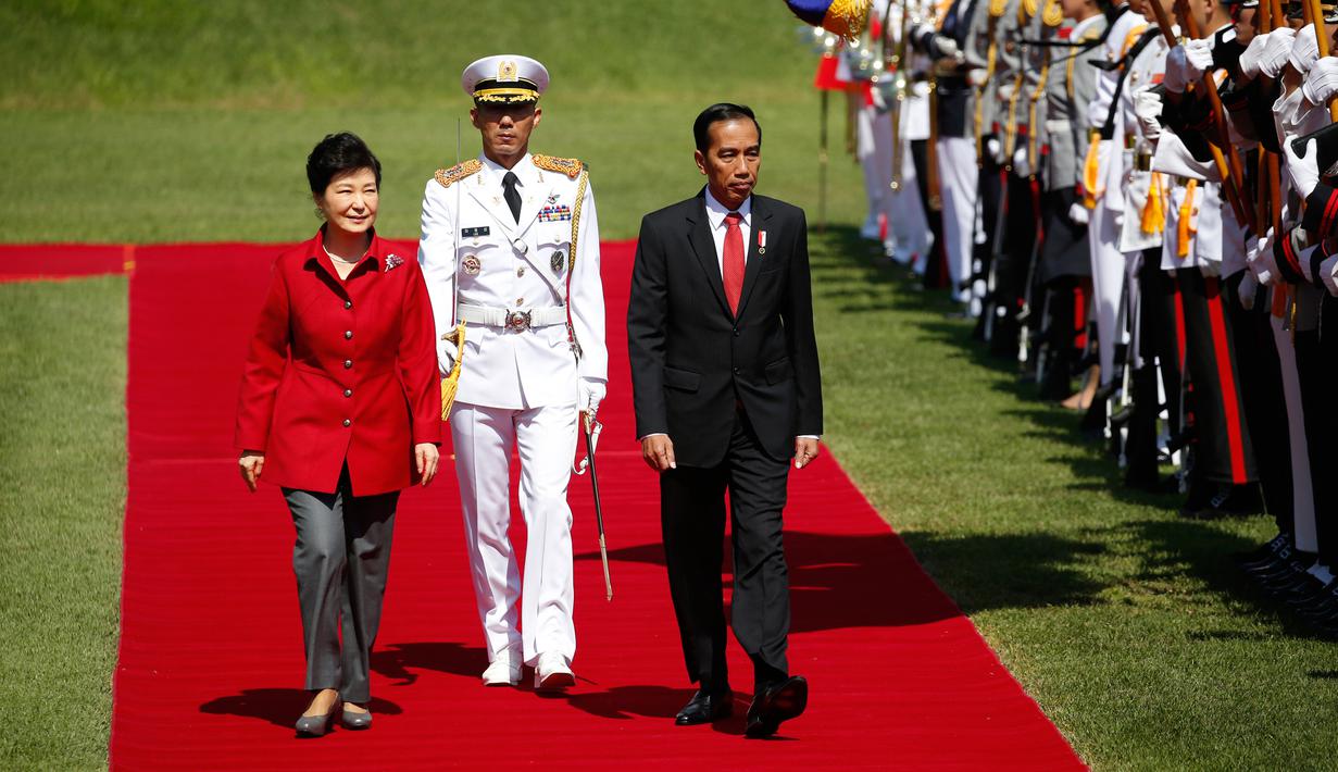 Presiden RI, Joko Widodo berjalan bersama Presiden Korea Selatan Park Geun-hye di Blue House, Korea Selatan (16/5). Jokowi dan Presiden Park melakukan pertemuan bilateral, termasuk untuk membahas 7 nota kesepahaman. (AFP PHOTO/KIM HONG-JI)