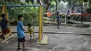 Anak-anak bermain ayunan di RPTRA Taman Kenanga, Jakarta, Selasa (28/9). Pemerintah Provinsi DKI Jakarta menargetkan pada tahun ini akan membangun 16 Ruang Publik Terpadu Ramah Anak (RPTRA). (Liputan6.com/Faizal Fanani)