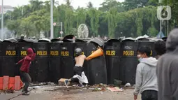 Pengunjuk rasa terlibat bentrok dengan polisi di Jalan Medan Merdeka Timur, Jakarta, Kamis (8/10/2020). Bentrokan terjadi akibat massa yang memaksa masuk ke depan Istana Negara untuk berunjuk rasa terkait penolakan UU Cipta Kerja. (Liputan6.com/Immanuel Antonius)