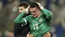 Pemain Irlandia Utara Kyle Lafferty (kanan) dihibur oleh rekan setimnya usai kekalahan mereka dari Slovakia pada pertandingan playoff babak semifinal Euro 2020 di Windsor Park, Belfast, Irlandia Utara, Kamis (12/11/2020). Slovakia lolos ke Euro 2020. (AP Photo/Peter Morrison)
