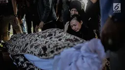 Kekasih almarhum Andika Putra Sahadewa, Nicky Santoso menangis di dekat makam di TPU Sunan Giri, Rawamangun, Jakarta, Selasa (10/9). Bassist grup band Kerispatih, Andika Putra Sahadewa, meninggal dunia di usia 36 tahun. (Liputan6.com/Faizal Fanani)