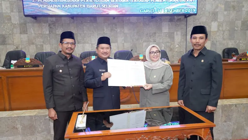 Bupati Garut Rudy Gunawan dan Ketua DPRD Euis Ida Wartiah, tengah menunjukan dokumen persiapan pembentukan DOB Garut Selatan dalam sidang paripurna