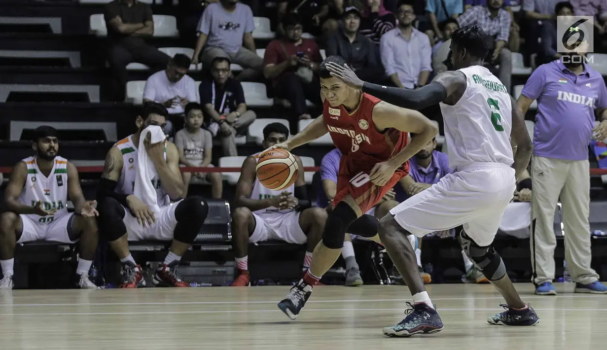 Pebasket putra Indonesia Kevin Yonas Argadiba Sitorus mencoba melewati pebasket India saat laga final bola basket 18th Asian Games Invitation Tournament di Hall Basket Senayan, Senin (12/2). Timnas Indonesia menang 78-68. (Liputan6.com/Faizal Fanani)