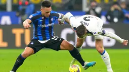 Pemain Inter Milan Lautaro Martinez berebut bola dengan pemain Atalanta Rafael Toloi (kanan) pada pertandingan sepak bola perempat final Coppa Italia di Stadion San Siro, Milan, Italia, 31 Januari 2023. Inter Milan menang 1-0 atas Atalanta dan berhasil melaju ke semifinal Coppa Italia. (AP Photo/Antonio Calanni)