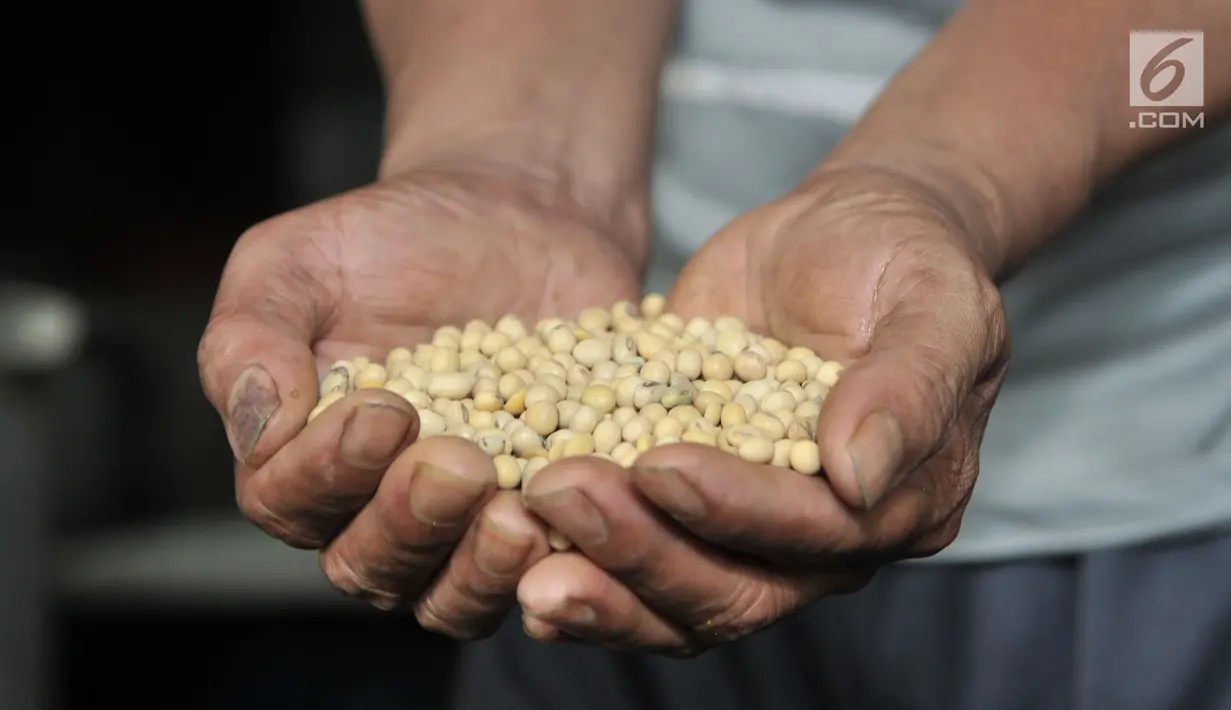 Pekerja memproses kacang kedelai menjadi tahu di salah satu industri rumahan Semanan, Kalideres, Jakarta, Rabu (19/9). Kenaikan dolar AS turut berdampak naiknya harga kedelai impor yang kini mencapai Rp 7.500 per kilogram. (Merdeka.com/Iqbal S Nugroho)