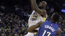 Pemain Warriors, Draymond Green (kiri) melakukan lay up melewati adangan pemain Orlando Magic, Jonathon Simmons (17) pada lanjutan NBA Basketball game di Oracle Arena, Oakland, (13/11/2017). Warriors menang 110-100. (AP/Ben Margot)