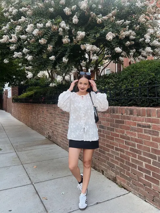 Enzy Storia terlihat feminin dengan busana kasual yang memadukan baloon sleeve dan rok hitam. Lengkapi outfitnya, Enzy pilih shoulder bag yang tipis dan sneakers putih [@enzystoria]