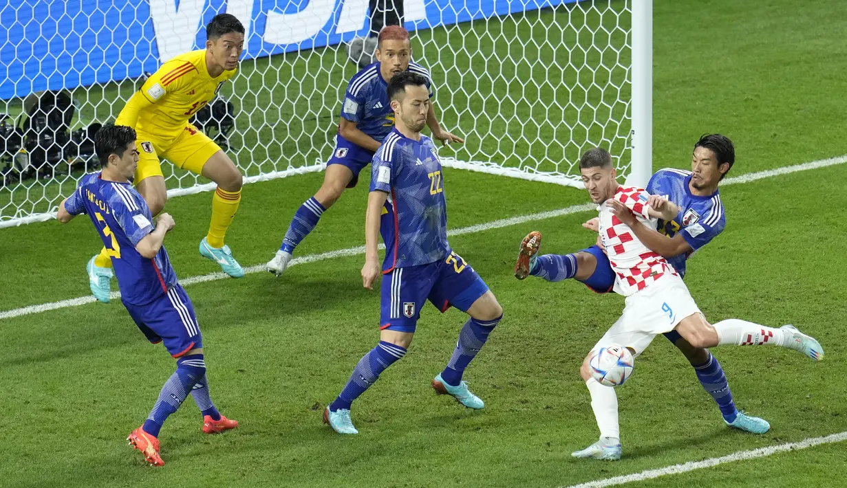 <p>Pemain Kroasia,&nbsp;Andrej Kramaric (kanan) berusaha mencetak gol ke gawang Jepang saat laga 16 besar Piala Dunia 2022 yang berlangsung di Al Janoub Stadium, Senin (05/12/2022). (AP/Ricardo Mazalan)</p>