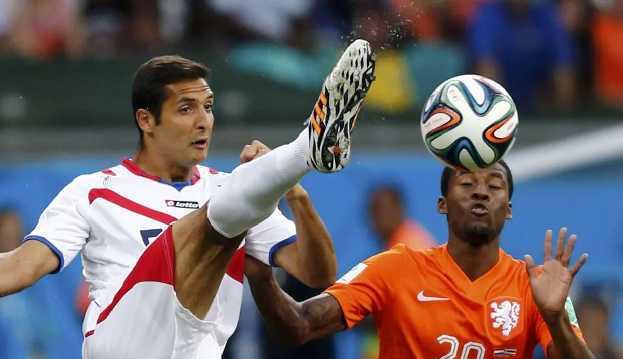 Gelandang Timnas Kosta Rika, Celso Borges (kiri), berusaha merebut bola dari Georginio Wijnaldum (Belanda) saat berlaga di perempat final Piala Dunia 2014 di Stadion Fonte Nova, Salvador, (6/7/2014). (REUTERS/Marcos Brindicci)