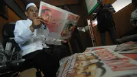 Pengasuh Ponpes Darul Ulum KH Cholil Dahlan membaca tabloid Obor Rakyat di Ponpes Darul Ulum Rejoso Peterongan, Jombang, Jawa Timur, Selasa (3/6). (ANTARA FOTO/Syaiful Arif)