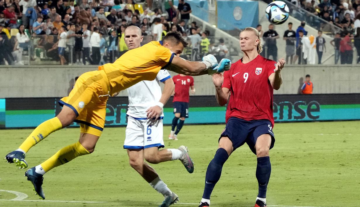 Pemain Norwegia, Erling Haaland (kanan) berebut bola dengan kiper Sipurs, Joel Mall pada laga Grup A Kualifikasi Euro 2024 di AEK Arena, Sipurs, Jumat (13/10/2023) dini hari WIB. Haaland mencetak gol pada menit ke-65 dan ke-72. (AP Photo/Petros Karadjias)