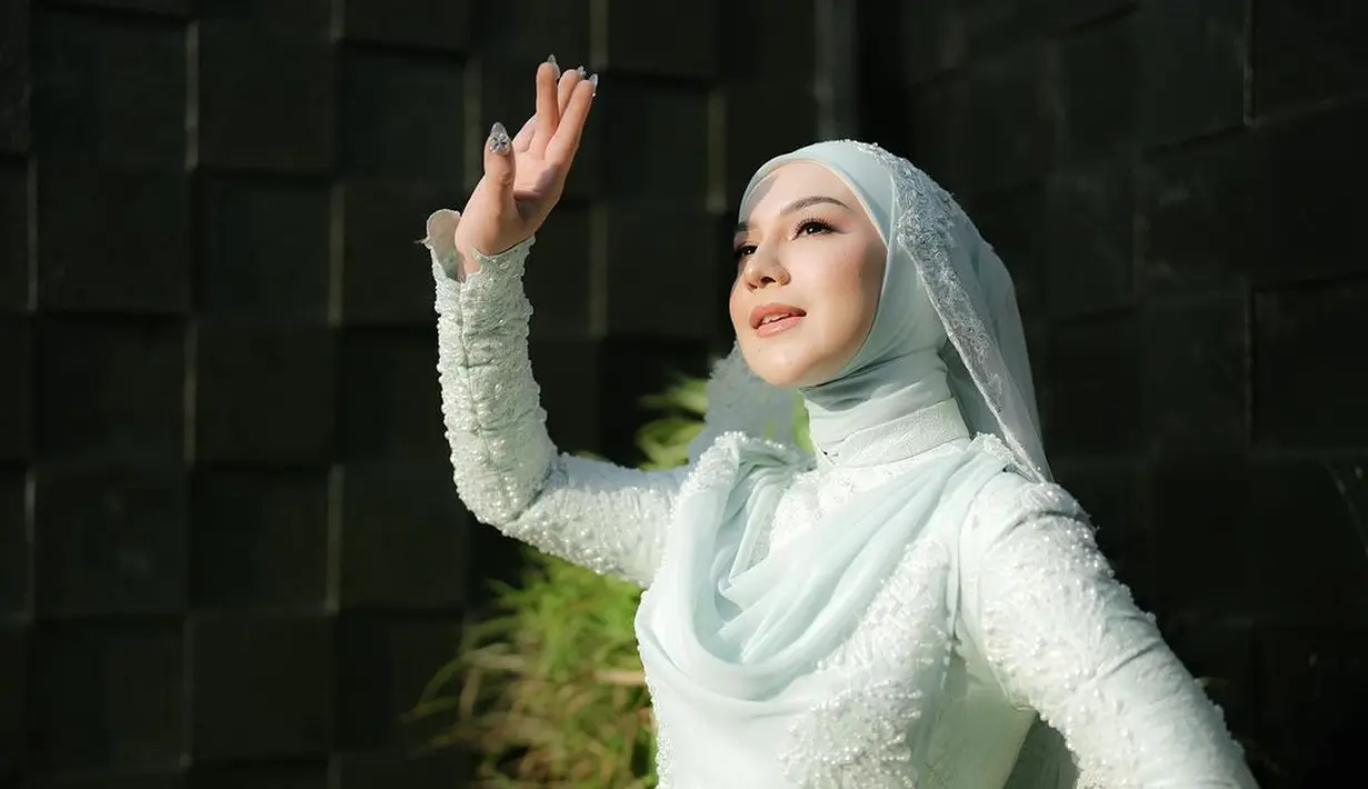 Kebaya tersebut kemudian dipadukan dengan hijab lilit polos bernuansa mint, Irish Bella juga kenakan kurung lace berwarna putih.