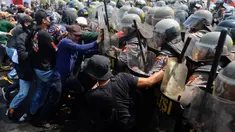 Pengunjuk rasa berupaya menerobos barikade personel kepolisian saat simulasi pengamanan Pemilu 2024 di halaman Kampus Universitas Islam Internasional Indonesia, Depok, Jawa Barat, Selasa (17/10/2023). (merdeka.com/Arie Basuki)