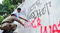 Sejumlah kelompok yang melakukan aksi Sahur On The Road ini mengotori dinding yang bertulisan SOTR di kawasan jalan Thamrin, Jakarta, Selasa (22/7/14) (Liputan6.com/Faizal Fanani)