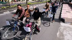 Sejumlah mahasiswa UGM berbusana batik saat pawai sepeda di kawasan Kridosono Yogyakarta, Minggu (2/10). Kegiatan tersebut untuk memperingati Hari Batik Nasional. (Liputan6.com/Boy Harjanto)