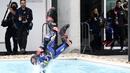 <p>Usai jumpa pers, rider Prancis ini kembali melakukan selebrasi heboh dengan melompat ke dalam kolam renang Sirkuit Portimao. (AP Photo/Jose Breton)</p>