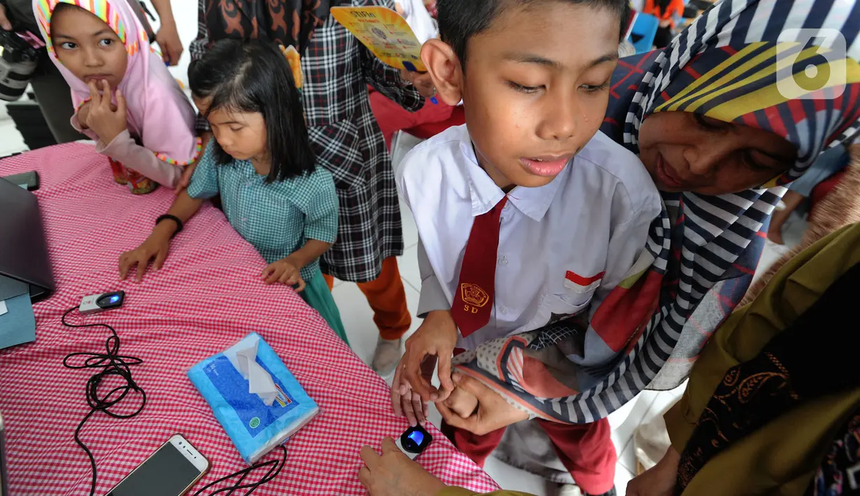 Murid-murid SLB mengikuti tes STIFIn di Sekolah Luar Biasa A Pembina Tingkat Nasional, Lebak Bulus, Jakarta, Selasa (17/12/2019). Tes tesebut dilakukan melalui menscan  ksepuluh ujung jari dengan mengambil waktu tidak lebih dari satu menit. (merdeka.com/Arie Basuki)