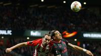Pemain Arsenal Hector Bellerin berebut bola di udara dengan pemain Atletico Madrid Diego Godin saat pertandingan semifinal Liga Europa di stadion Metropolitano di Madrid (3/5). (AP Photo / Francisco Seco)