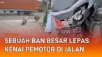 Rekaman CCTV menunjukkan sebuah ban besar lepas dan mengenai pemotor di jalan.