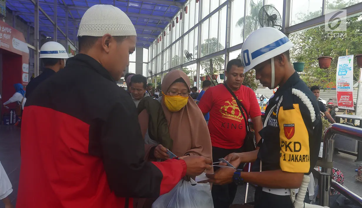 Petugas memeriksa tiket dan kartu identitas di Stasiun Senen, Jakarta, Jumat (8/6). Berdasarkan data yang dihimpun humas Stasiun Pasar Senen, jumlah keberangkatan penumpang sampai hari ini mencapai 24.922 ribu. (Merdeka.com/Imam Buhori)
