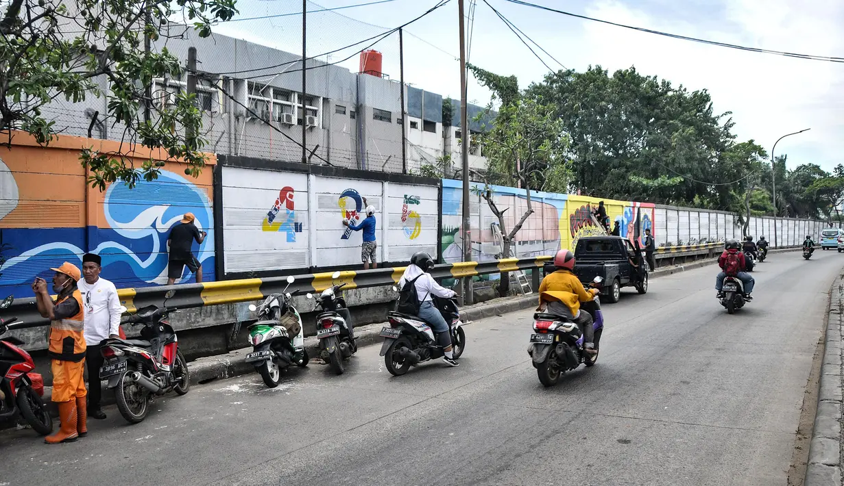 Pengendara melintas saat petugas Penanganan Prasaranan dan Sarana Umum (PPSU) menyelesaikan pembuatan mural di Jalan RE Martadinata, Tanjung Priok, Jakarta Utara, Selasa (24/5/2022). Pembuatan mural di sepanjang Jalan RE Martadinata yang dilakukan oleh petugas PPSU dari 19 kelurahan di Jakarta Utara tersebut dalam rangka menyambut balapan Formula E dan HUT ke-495 Kota Jakarta. (merdeka.com/Iqbal S Nugroho)