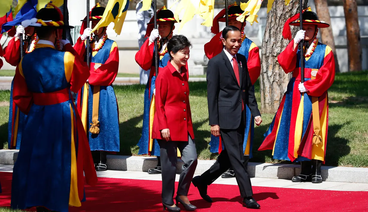 Presiden RI, Joko Widodo berjalan bersama Presiden Korea Selatan Park Geun-hye di Blue House, Korea Selatan (16/5). Jokowi dan Presiden Park melakukan pertemuan bilateral, termasuk untuk membahas 7 nota kesepahaman. (AFP PHOTO/KIM HONG-JI)