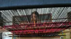 Seorang perajin menenun kain songket di sentral kerajinan songket Patuh, Desa Sukarara, Lombok Tengah, Selasa (13/10). Desa Sukarara menjadi salah satu penghasil kain tenun khas suku Sasak, Lombok. (Liputan6.com/Gempur M Surya)