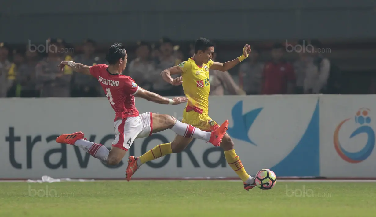 Aksi Bhayangkara FC, Dendi Sulistyawan melewati pemain Persija Jakarta, Ryuji Utomo pada lanjutan Liga 1 2017 di Stadion Patriot Bekasi, Sabtu (12/11/2017). Bhayangkara kalah dari Persija 1-2. (Bola.com/Nicklas Hanoatubun)