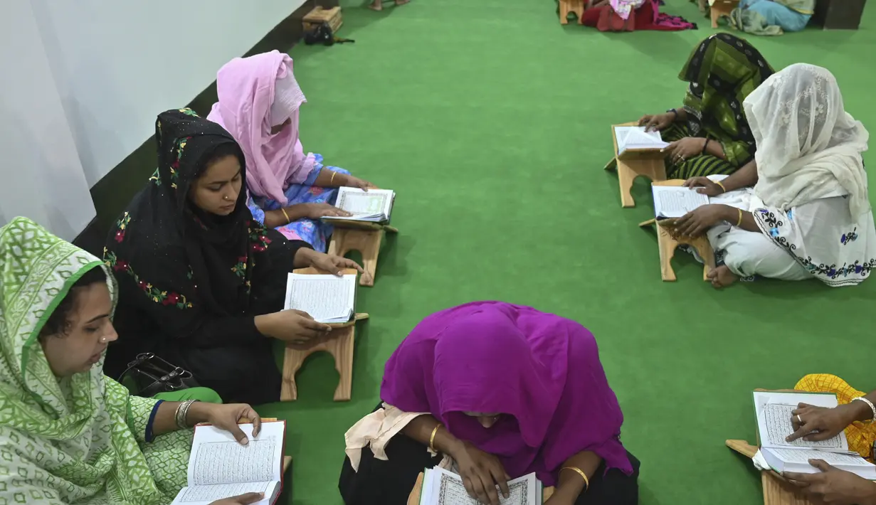 Anggota komunitas transgender belajar membaca Alquran di dalam Madrasah Dawatul Islam Tritio Linger untuk jenis kelamin ketiga, di Dhaka, Bangladesh, Selasa (17/11/2020). Pendirian madrasah ini dianggap salah satu upaya Bangladesh untuk membuat hidup kaum LGBT lebih mudah. (Munir Uz zaman/AFP)