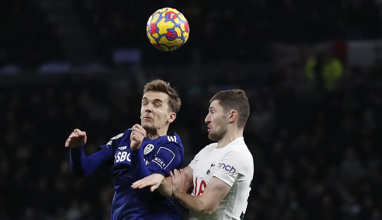 Bek Leeds United Diego Llorente (kiri) berebut bola dengan bek Tottenham Hotspur Ben Davies (kanan) pada pekan ke-12 Liga Inggris di Tottenham Hotspur Stadium, London, Minggu (21/11/2021). Sempat tertinggal, Tottenham Hotspur menumbangkan Leeds United 2-1. (Adrian DENNIS / AFP)