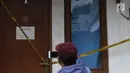 Garis pembatas terpasang di lokasi pembunuhan wanita yang ditemukan tewas di dalam lemari di kawasan Mampang, Jakarta, Jumat (23/11). Polres Jaksel menggelar rekonstruksi setelah penyidik menggali keterangan pelaku. (Liputan6.com/Helmi Fithriansyah)