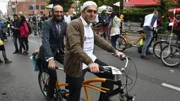 Imam Osman Oers (depan) dan Rabbi Akiva Weingarten mengayuh sepeda tandem sebagai kampanye lintas agama melintasi Ibu Kota Jerman, Berlin, 24 Juni 2018. Kegiatan ini untuk menunjukkan bahwa Muslim dan Yahudi bisa hidup berdampingan. (AFP/John MACDOUGALL)