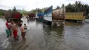 Anak-anak bermain di Sungai Kilo Sembilan, Popayato, Gorontalo, Minggu (11/9). Sungai tersebut juga dimanfaatkan sopir untuk membersihkan truk  dan mencuci pakaian  (Liputan6.com/Immanuel Antonius)