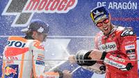 Pembalap Ducati, Andrea Dovizioso (kanan), berselebrasi dengan Marc Marquez setelah balapan MotoGP Aragon, Minggu (22/9/2019). (AFP/Javier Soriano)