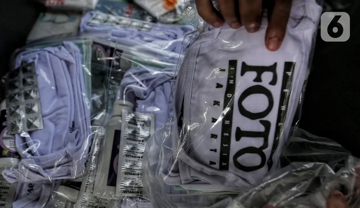 Paket penunjang liputan yang diterima anggota Pewarta Foto Indonesia Jakarta (PFIJ), Jakarta, Rabu (22/4/2020). PFIJ membagikan 230 paket penunjang liputan berupa masker, hand sanitizer, dan multivitamin kepada anggotanya yang melaksanakan tugas jurnalistik selama pandemi. (Liputan6.com/Johan Tallo)