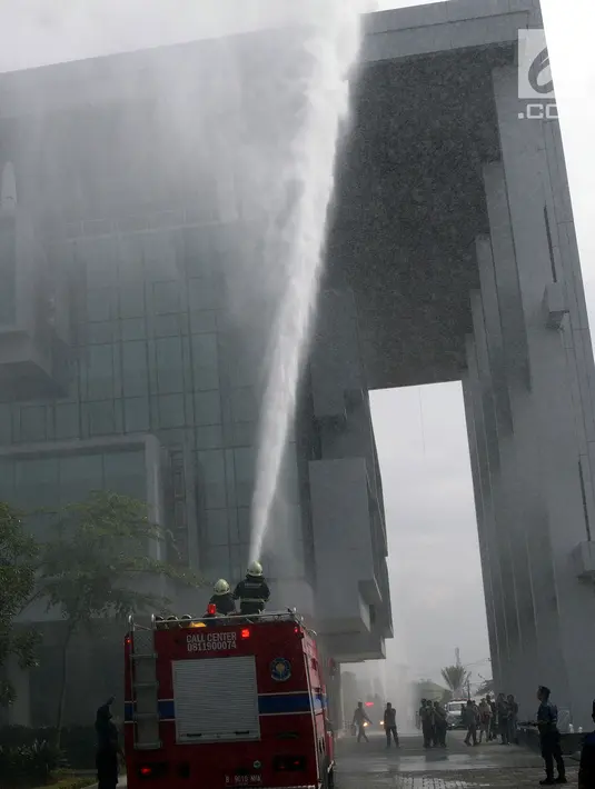 Petugas pemadam menyemprotkan air ke gedung saat simulasi penanggulangan kebakaran dan gempa bumi di Balai Kota Tangsel, Banten, Kamis (26/4). Hal ini untuk meningkatkan kesiapsiagaan, kecepatan, dan ketepatan dalam penyelamatan. (Merdeka.com/Arie Basuki)